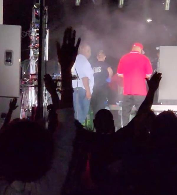 EMS workers administering CPR to rapper Fatman Scoop behind a stage partition after his collapse during a performance