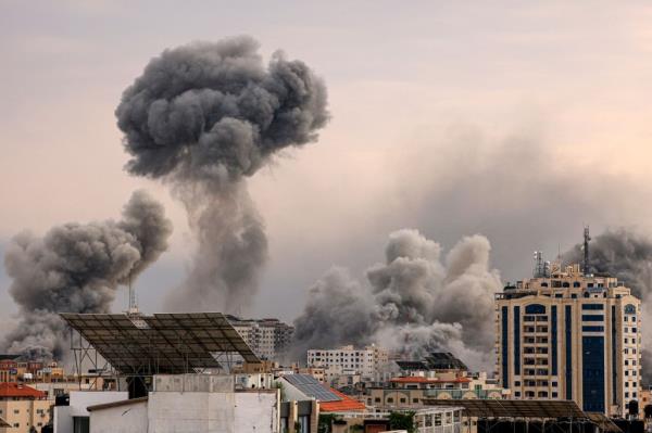 A plume of smoke rises in the sky of Gaza City during an Israeli airstrike on October 9.