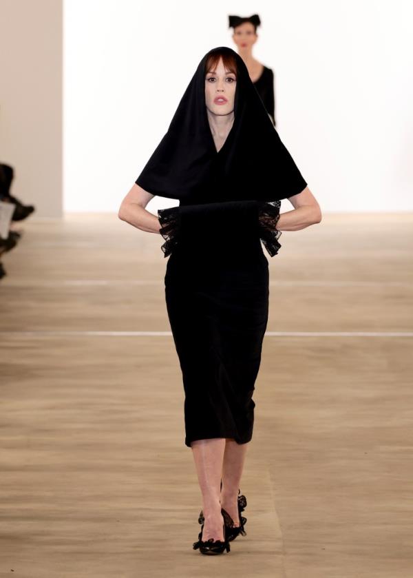 Molly Ringwald walking the runway in a black dress at Batsheva fashion show during NYFW.