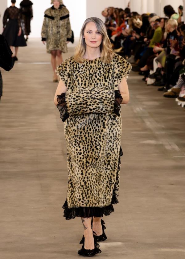 A model walks the runway in a Batsheva fashion show wearing a leopard print dress and high heels in February 2024 during New York Fashion Week.