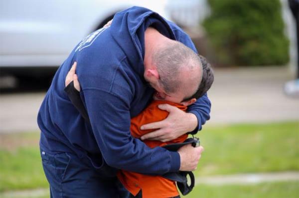 Man embraces boy