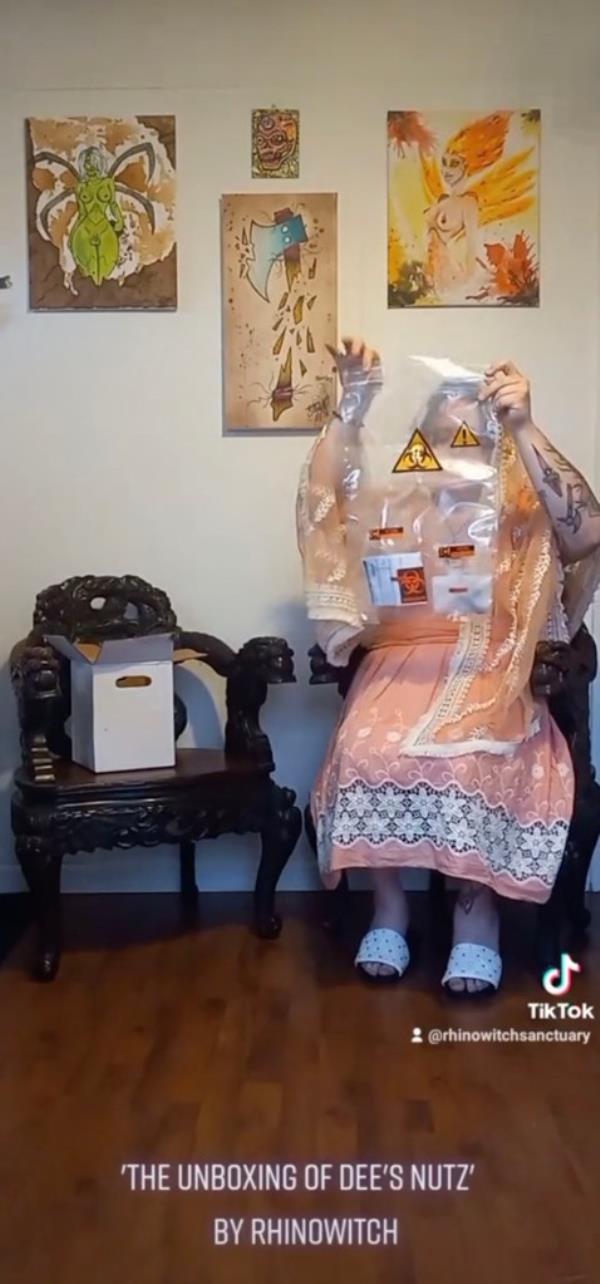 Kinglsley holding up a bag marked as a biohazard