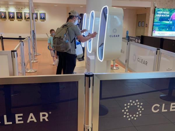 Passengers using CLEAR identity co<em></em>nfirmation kiosk at West Palm Beach Airport, Florida