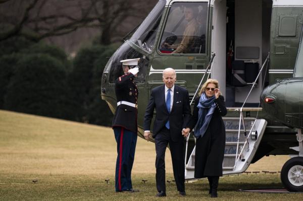President Joe and Dr. Jill Biden walk on South Lawn, with the White House in the background, in Washington, DC, USA.