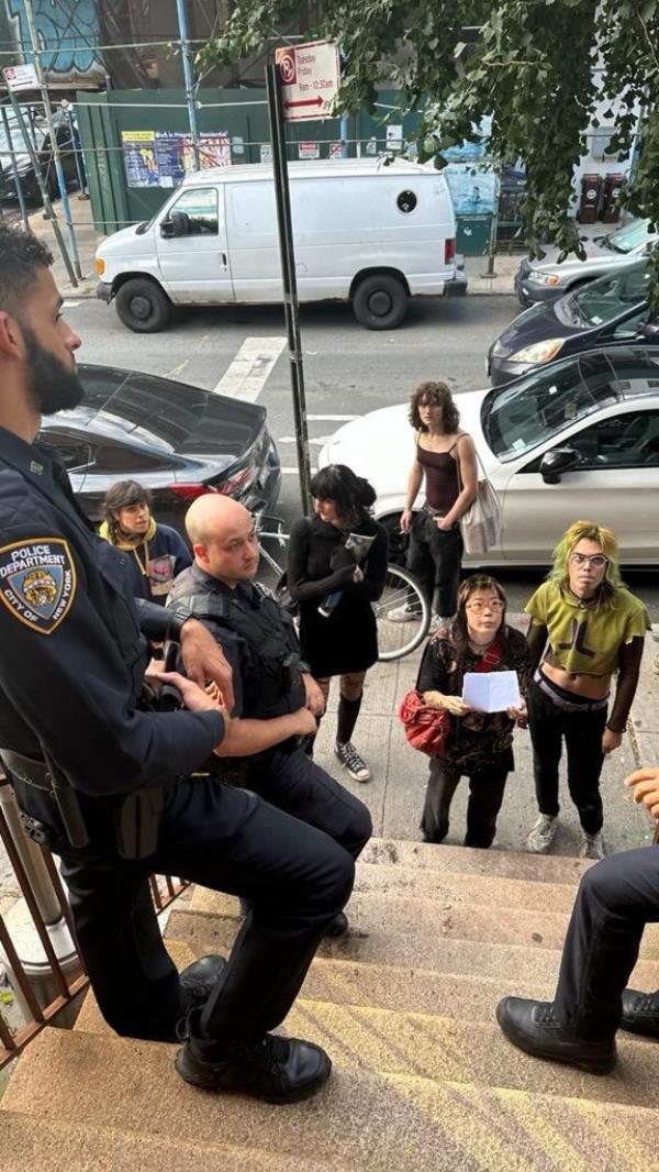 Police are pictured outside the brownstone on Monday.