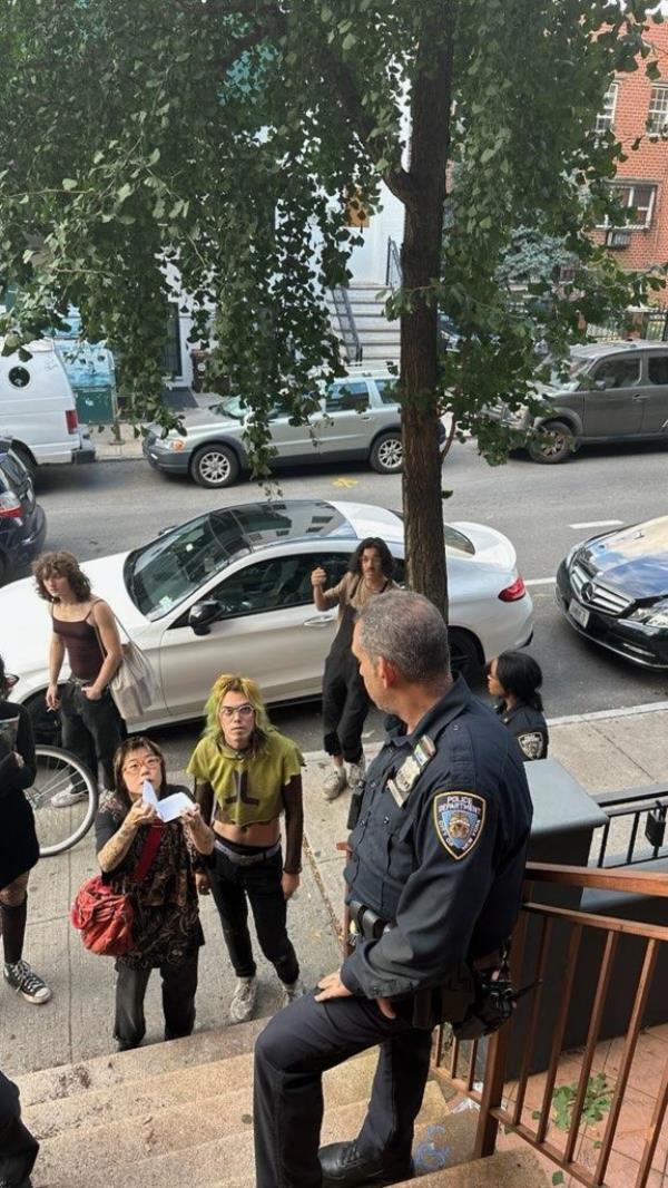 A photo showing the group presenting a fraudulent lease to cops.
