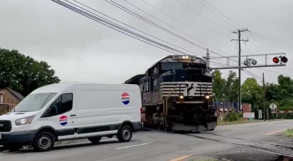 The van then crosses over the tracks, narrowly avoiding being turned into twisted me<em></em>tal by the train.