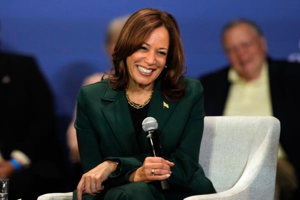 Democratic presidential nominee Vice President Kamala Harris speaking into a microphone at a campaign event in Brookfield, Wisconsin, 2024