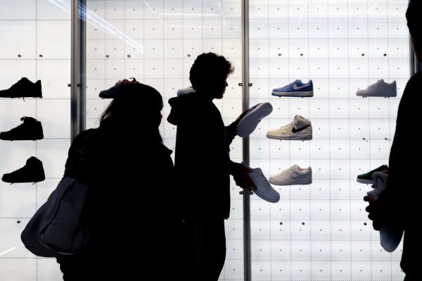People shop for shoes in a Nike store on Black Friday, Nov. 25, 2022, in New York.