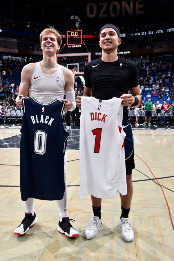 Gradey Dick #1 of the Toro<em></em>nto Raptors and Anthony Black #0 of the Orlando Magic swap jerseys after the game on March 17, 2024.