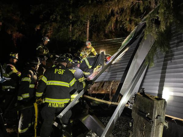 Firefighters respond to a tree that fell on a trailer in Maple Valley.
