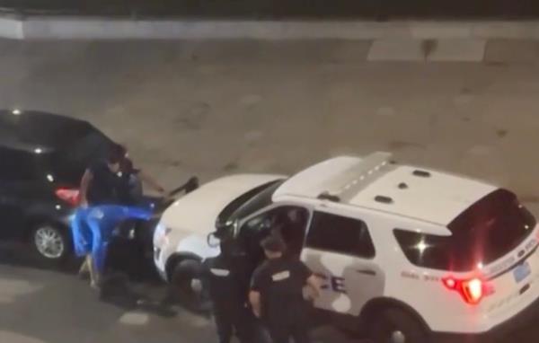 The cop gave one of the men the keys, and he jumped in and put the cruiser in reverse. 