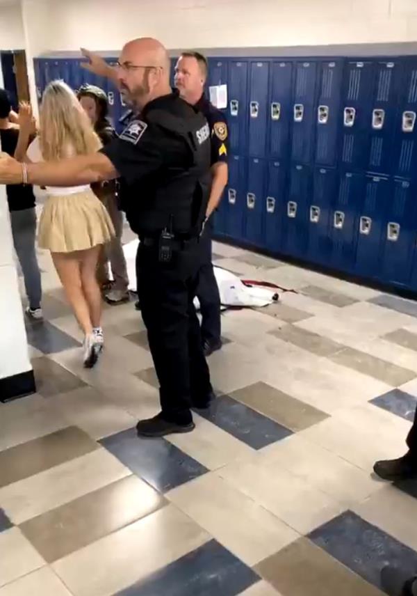 Police usher students down the hallway