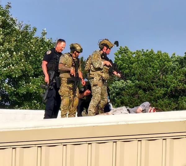 Federal agents speaking to an individual at the doorway of Thomas Matthew Crooks' home in Bethel Park, Pennsylvania, following an assassination attempt