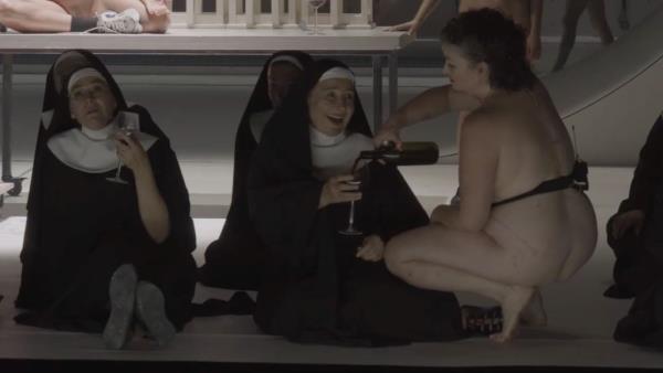A naked woman pours a nun a glass of wine
