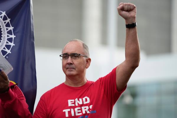 United Auto Workers President Shawn Fain raises his fist at a rally in Detroit, on Sept. 15, 2023.