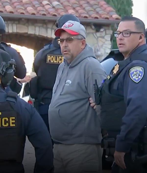A man in a cap accompanied by police officers, related to news story a<em></em>bout a rich mother involved in organized crime