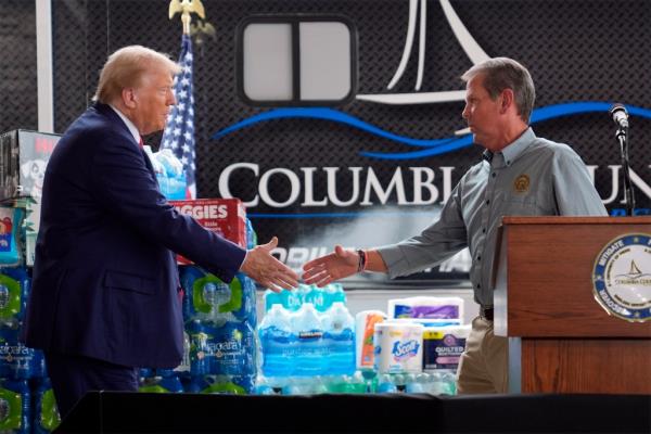 Do<em></em>nald Trump shakes hands with Georgia Gov. Brian Kemp at a temporary relief shelter as he visits areas impacted by Hurricane Helene, Friday, Oct. 4, 2024, in Evans, Ga.