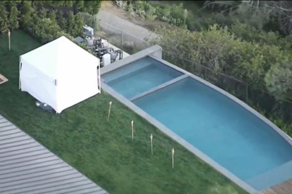 White tent in Matthew Perry's backyard wher<em></em>e he was found deceased, with visible pool in the background