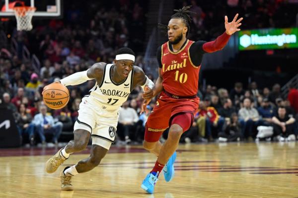 Nets guard Dennis Schroder (17) dribbles beside Cleveland Cavaliers guard Darius Garland (10) in the second quarter.