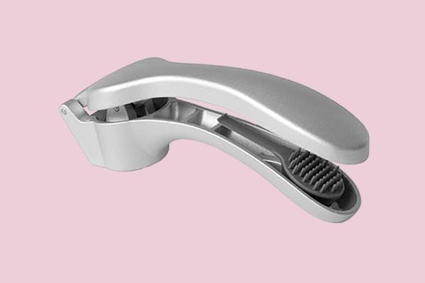 Eva Lo<em></em>ngoria holding a silver garlic press