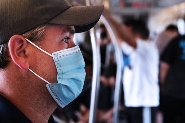 Sgt. John Pritchard on the subway and wearing a medical mask