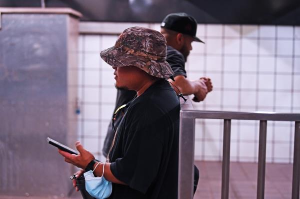 NYPD undercover officer on a subway platform