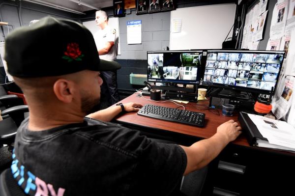 NYPD pickpocket team's officers watching video footage of subway riders