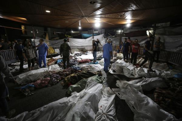 Bodies of Palestinians killed by an explosion at the Ahli Arab hospital are gathered in the front yard of the al-Shifa hospital, in Gaza City, central Gaza Strip, Tuesday, Oct. 17, 2023. 