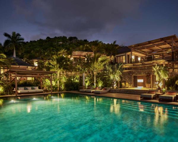 The bungalows, spread across staggered levels, include a primary suite, family room, restaurant-grade kitchen, dining room, guest cottage, and caretaker’s house, all centered around a pool.