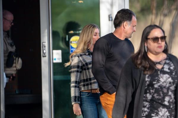 Becky Renner (left) and Travis Renner (right), parents of Talan Renner, are escorted out through a back exit by Maricopa County deputy sheriffs after attending their son's first appearance in court in the case of Queen Creek teen Preston Lord's murder, at the Durango Juvenile Court in Phoenix on March 7, 2024