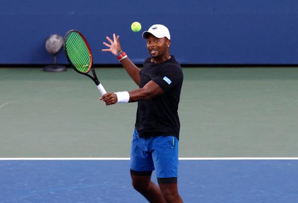Do<em></em>nald Young hitting a return in a mixed doubles match at the 2024 US Open Championship.