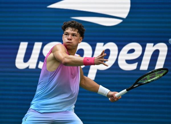 Ben Shelton swinging a tennis racket during a match against Frances Tiafoe at the US Open in Arthur Ashe Stadium, August 30, 2024.