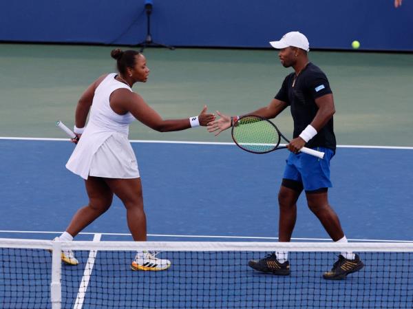 Do<em></em>nald Young and Taylor Townsend shaking hands on a tennis court during their doubles match at the 2024 US Open Championship