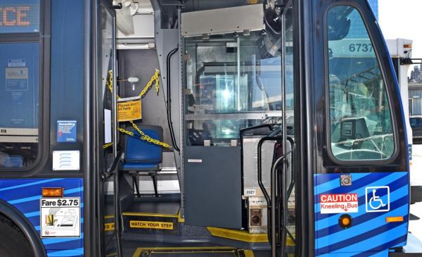 The MTA will be installing permanent partitions (pictured) near the bus driver's seat to allow passengers to o<em></em>nce again enter the vehicle through the front door of the buses. 