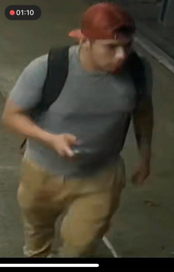 The alleged burglar walking down the street.