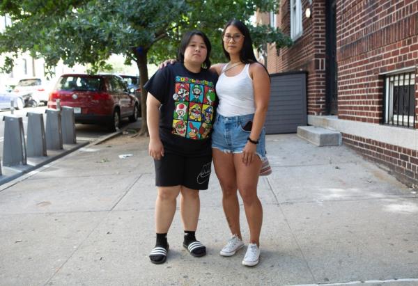 Volunteers Raquel Matuguina and Lia Tracy posing on a sidewalk, involved in the search for missing bodega cat Anto<em></em>nio from the K'Glen Deli & Sari-Sari Store in Queens, 2024.