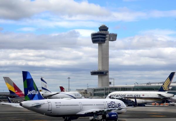 A JetBlue Airways Airbus A321 passenger jet aircraft taxis past several other planes parked at John F. Kennedy Internatio<em></em>nal Airport in the New York City