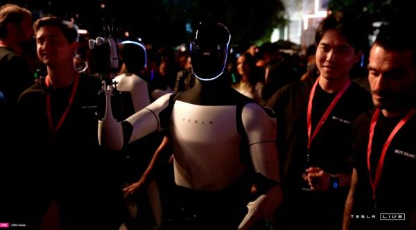 Optimus robot gestures in middle of human crowd during event on Oct. 10, 2024.