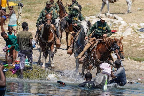 Horseback Border Patrol agents respond to a massive encampment of Haitian migrants