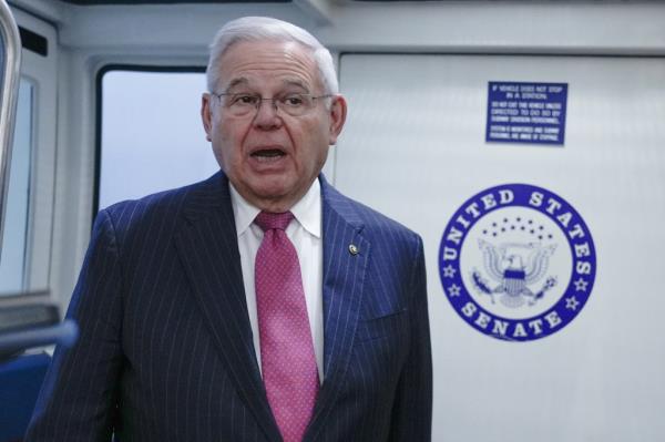 Sen. Bob Menendez, D-N.J., talks with reporters in the Senate Subway at the US Capitol Thursday, Feb. 8, 2024, in Washington.