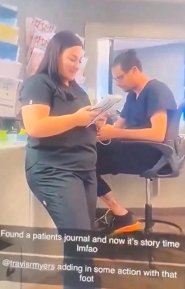 Woman in scrubs reads a diary.