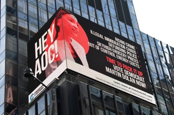 Electro<em></em>nic billboard running ads against AOC on the side of a building at 1500 Broadway in Times Square