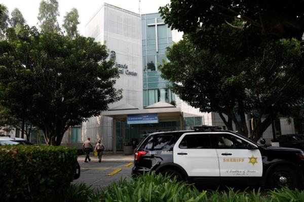 Los Angeles County Sheriffs Department (LASD) deputies walk outside St. Francis Medical Center hospital 