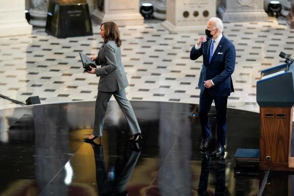 President Joe Biden and Vice President Kamala Harris cross paths as they deliver respective remarks to mark the one-year anniversary of the January 6th Capitol insurrection in Statuary Hall on Capitol Hill on January 6, 2022 in Washington, DC.