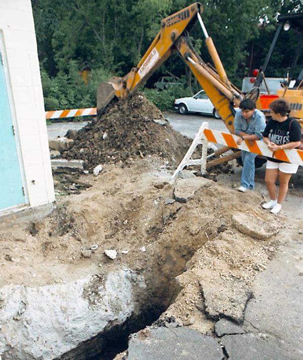 Workers excavate the parking lot of the Good 'n Loud Music in Madison, Wis., in 1989 