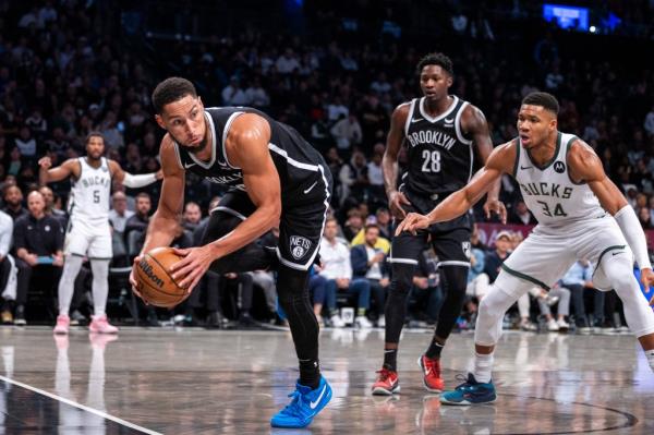 Ben Simmons tries to save a ball out of bounds against the Bucks on Mo<em></em>nday night.