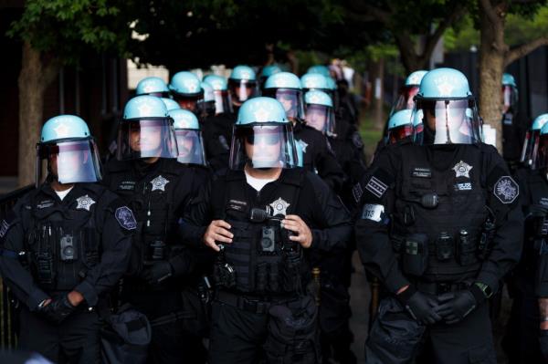 Chicago Police officers in black uniforms massing to remove protesters from Park #578 near the Democrat Natio<em></em>nal Convention's security perimeter, United Center, Chicago, August 19, 2024.