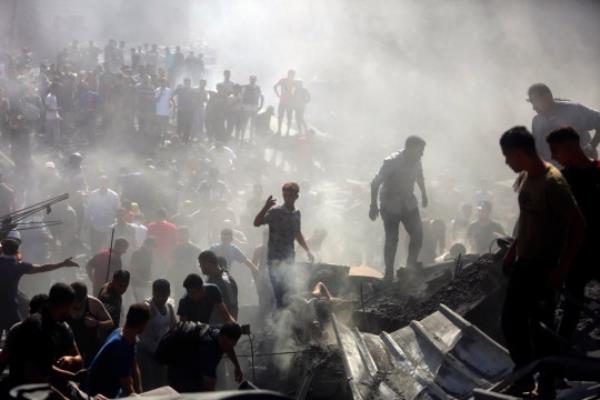 Palestinians inspect the rubble of destroyed buildings following Israeli airstrikes on the town of Khan Younis, southern Gaza Strip, Thursday, Oct. 26, 2023