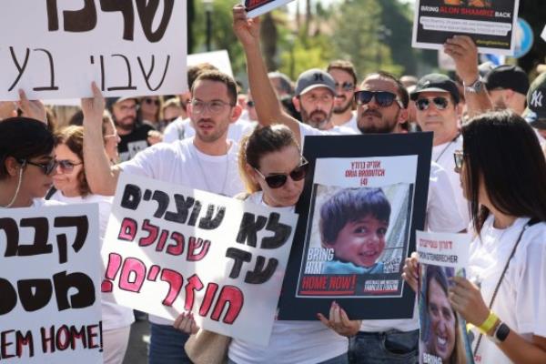 A woman holds a poster identifying one of the Israeli hostages, four-year-old Oria Brodutch, held by Palestinian militants since the October 7 attack, during a demo<em></em>nstration in solidarity with them in Tel Aviv on October 26, 2023